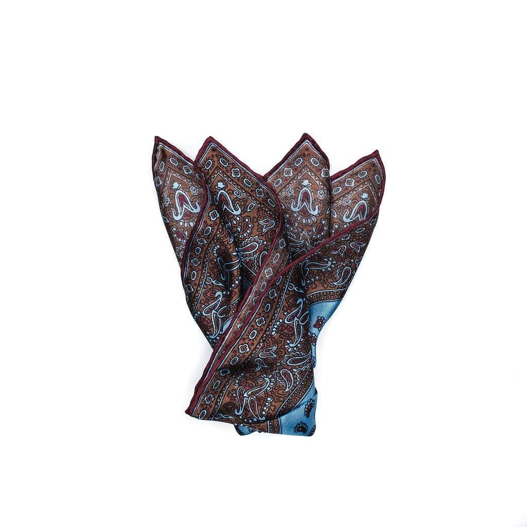 100% pure silk pocket square features a micro paisley motif, edged with decorative paisley border pattern. Sky Blue silk with butterscotch and burgundy edging rounds out this gorgeous decorative sartorial accessory.